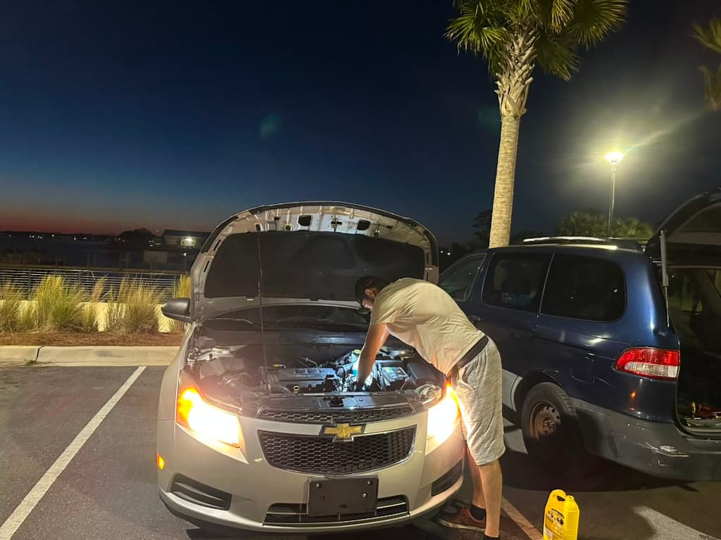 Evening mobile repair service, headlights on for visibility